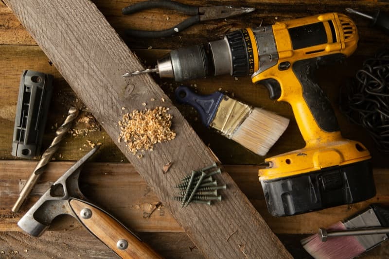 Assorted DIY tools and wood shavings on a workbench